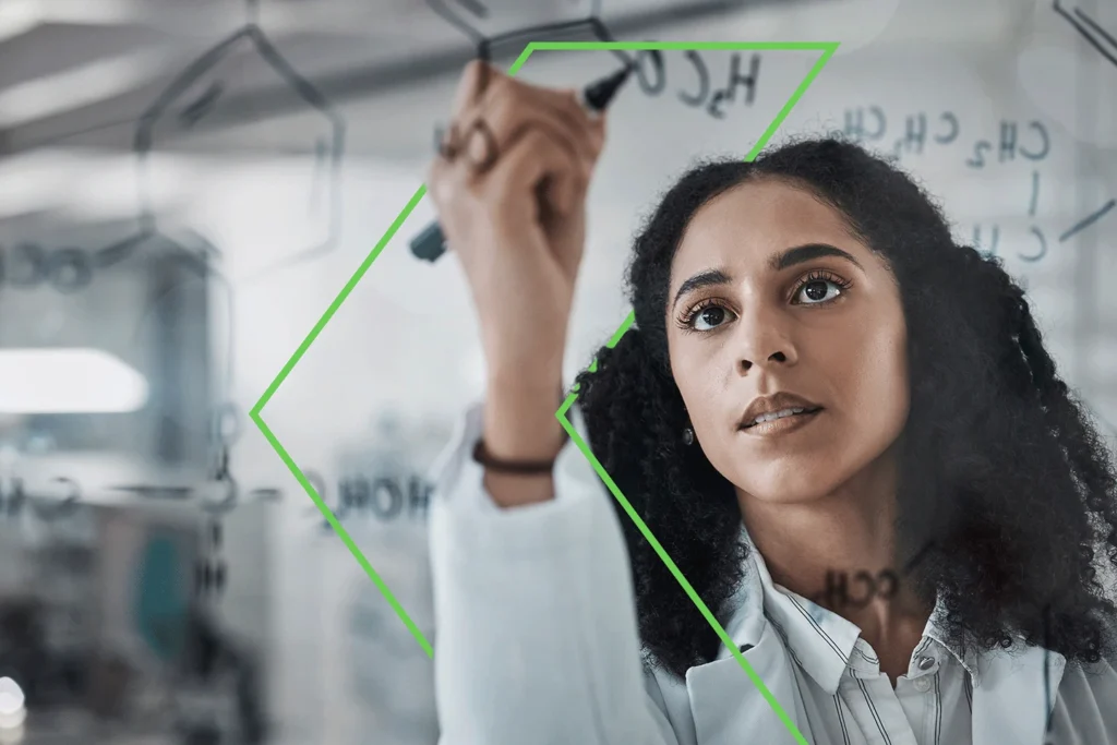Scientist analyzing data on glass board, representing SAI MedPartners’ strategic support in navigating the complex biosimilars landscape.